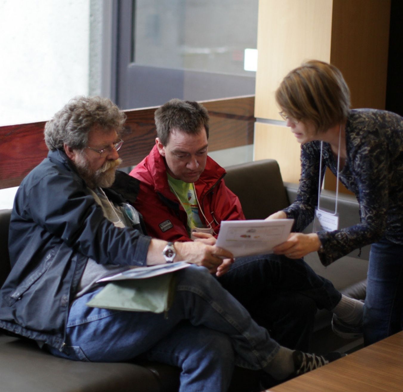 L'Arche members looking at papers together